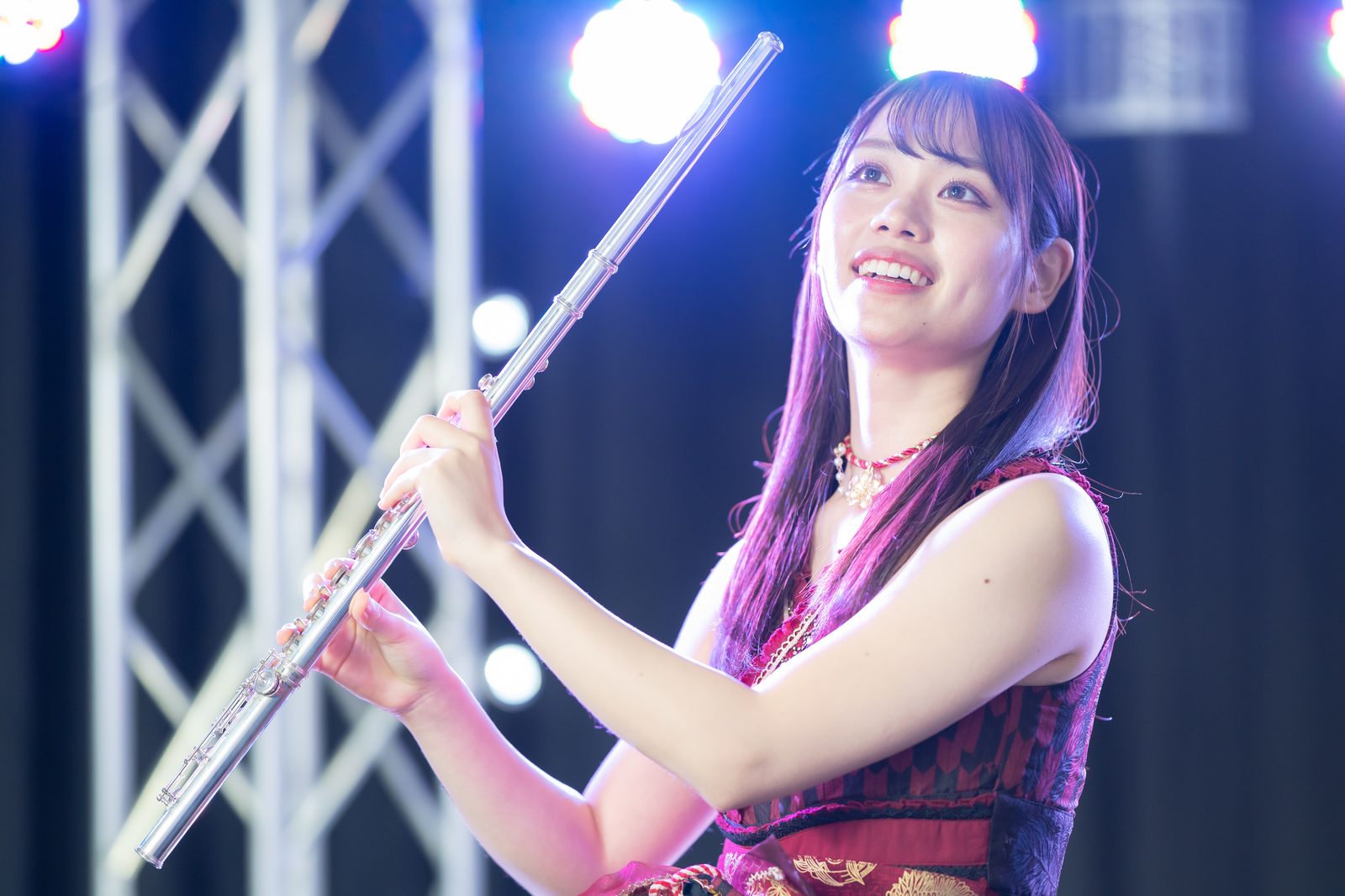 KATOROLL playing the flute under stage lights